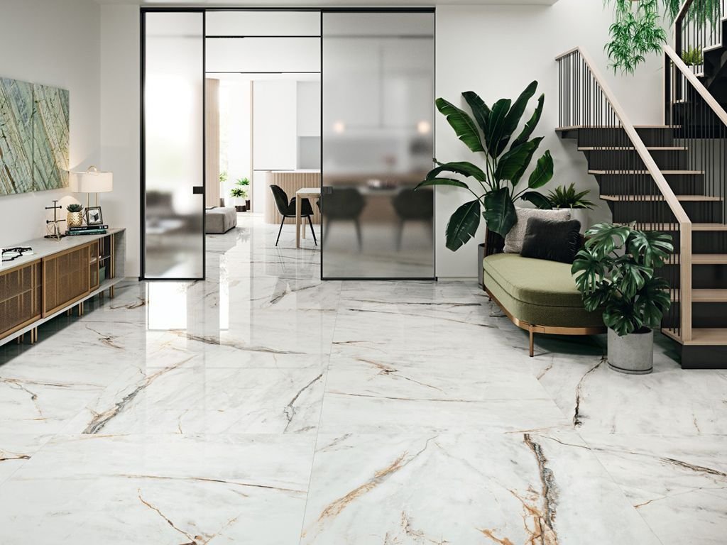White and gold marble-effect porcelain running through a bright open hallway